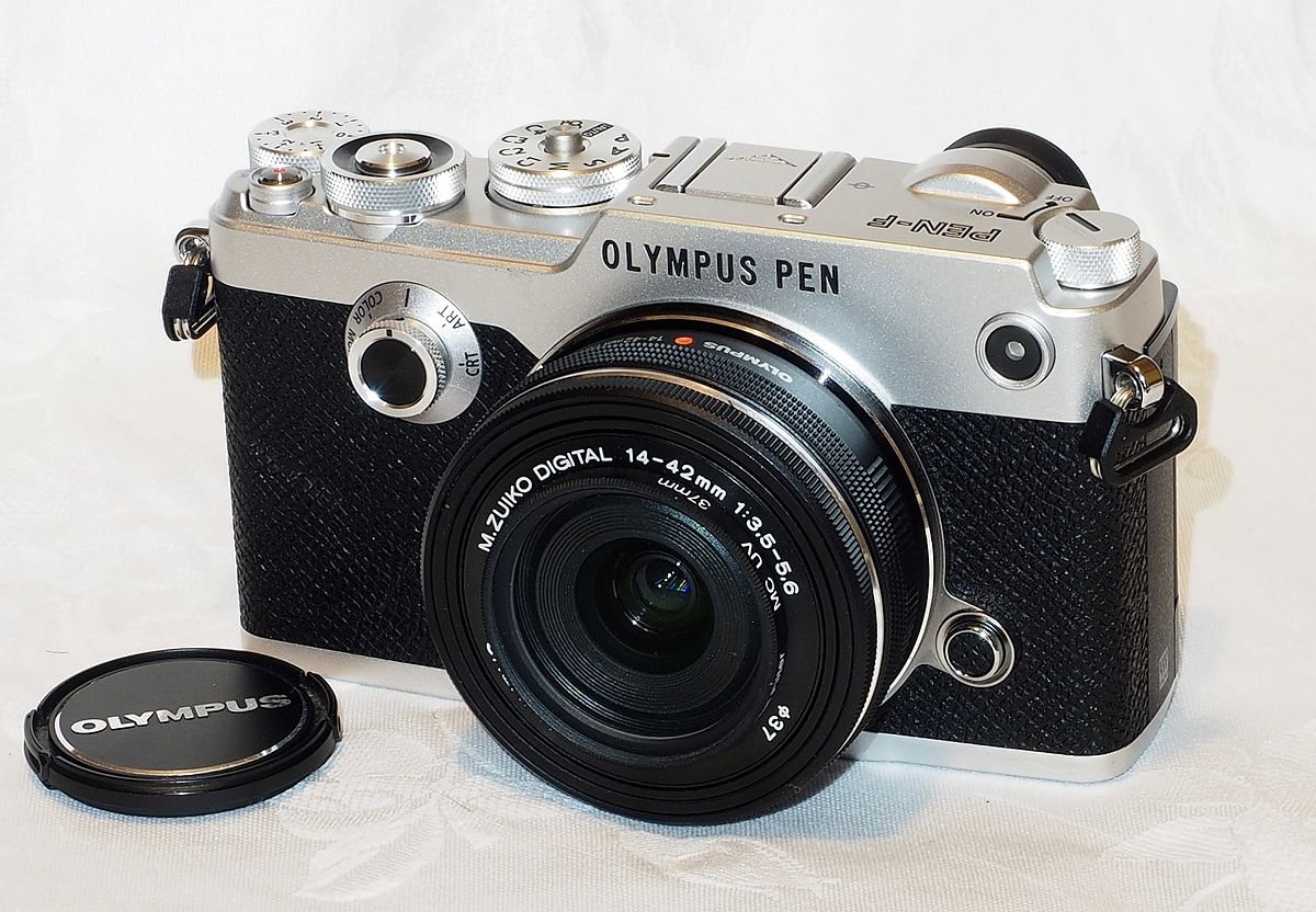 An Olympus compact-camera image connecting the essay to everyday carry cameras.