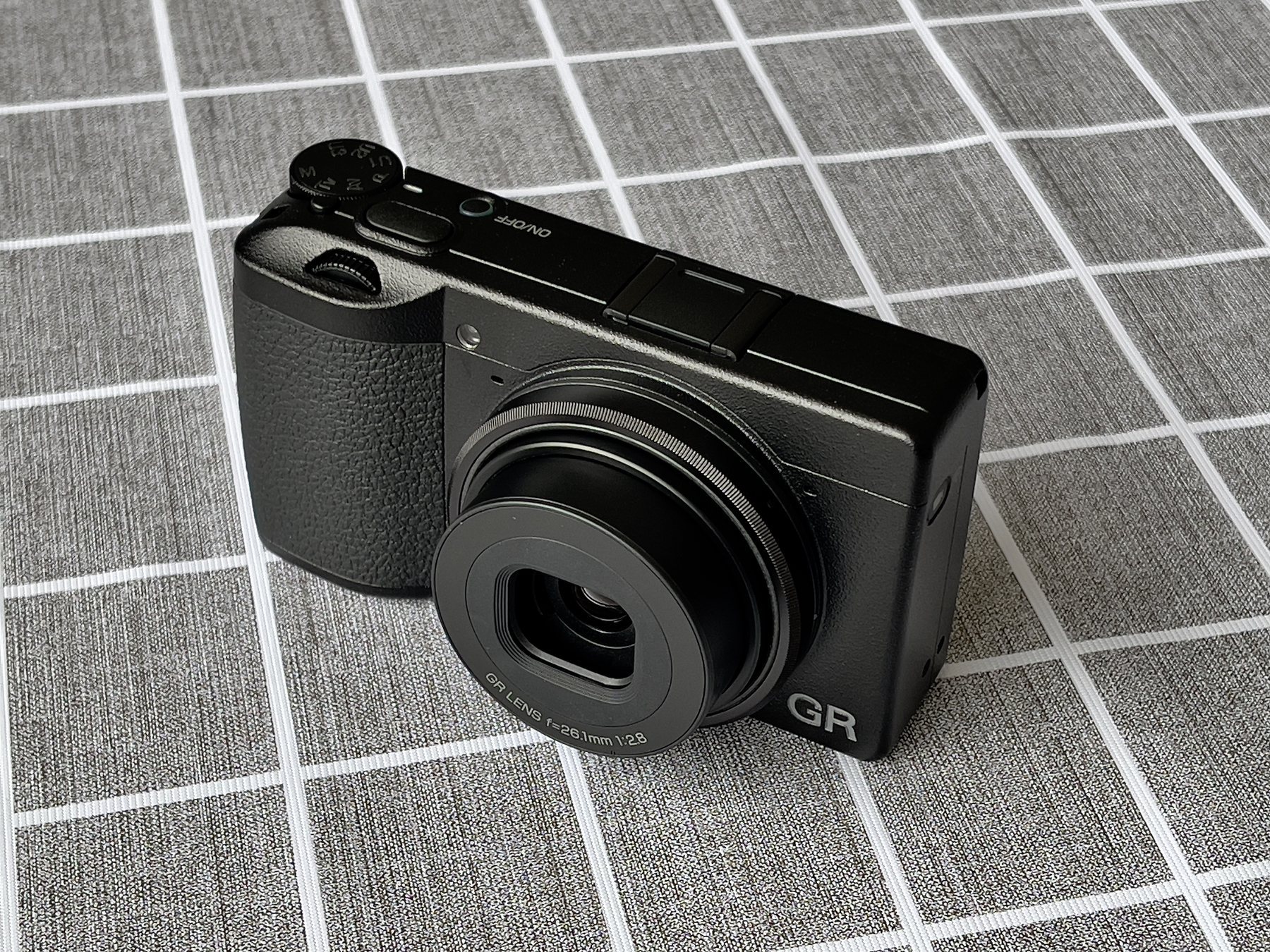 The Ricoh GR approach is the opposite of pocket zoom: fixed-lens discipline, larger-sensor stills, and fast everyday handling.